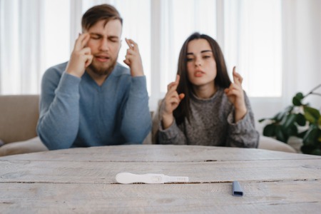Hopeful couple checking a pregnancy test.の写真素材