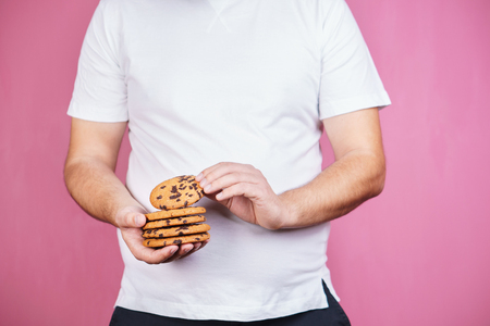 sugar addiction, obese man with stack of cookiesの写真素材