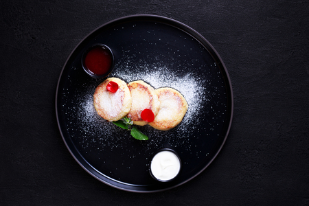 Cottage cheese pancakes with jam and sour creamの写真素材