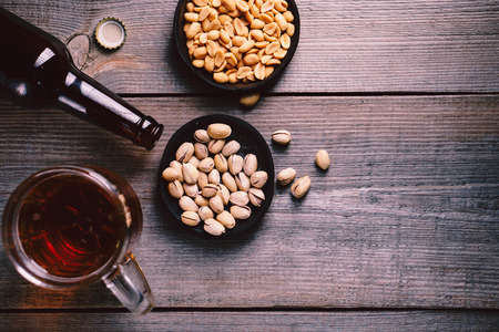 Beer and snacks on dark tableの写真素材