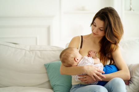 Young mother breastfeeding her little sonの写真素材
