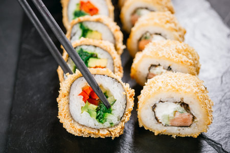 Tempura maki. Japanese sushi roll on wooden plateの写真素材