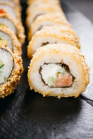 Tempura maki. Japanese sushi rolls on black slateの写真素材