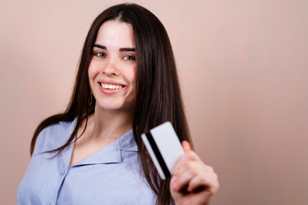 Young cheerful woman holding credit cardの写真素材