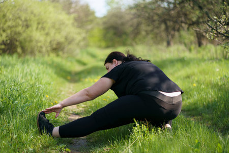 Overweight woman stretching legs doing exercises