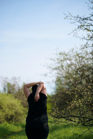 Overweight woman stretching hands relaxingの写真素材