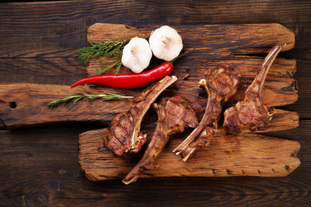 Spicy grilled lamb ribs loin on serving board