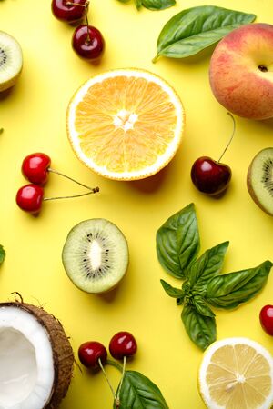Summer fruity composition. Layout made of delicious ripe fruits on bright yellow background. Summertime, healthy food, delicious sweet dessertの写真素材