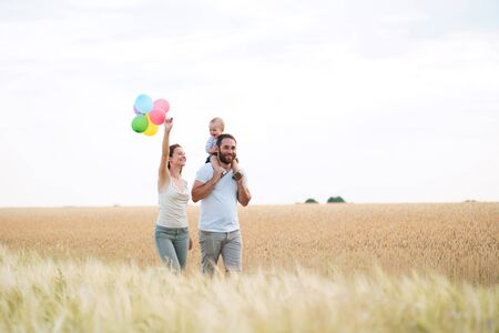 Daddy, mom and child having fun outdoorsの写真素材