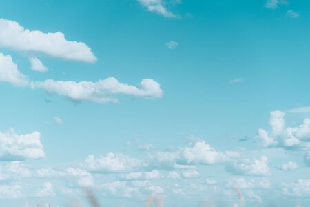 Light blue sky with clouds and sunの写真素材