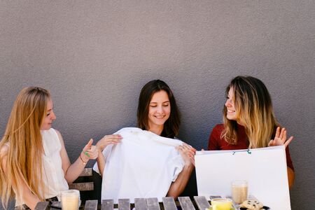 Good purchase. Women look at new t-shirt approveの写真素材