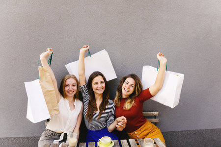 Happy women friends do shopping together