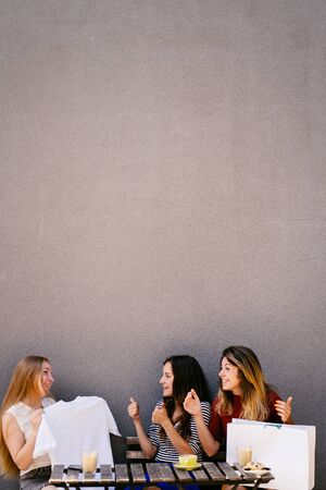 Good purchase. Women look at new t-shirt approveの写真素材