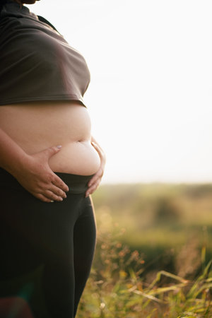 Overweight woman walking outdoors, cropped portrait