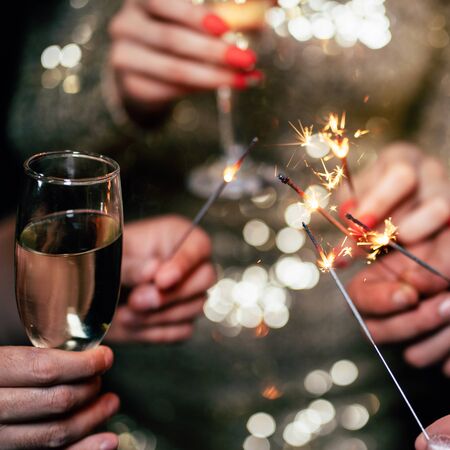 Friends celebrate clinking with champagne glassesの写真素材