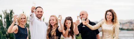 Happy friends with drinks, celebrating special dayの写真素材