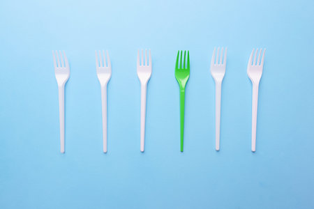 Recycling plastic forks on blue