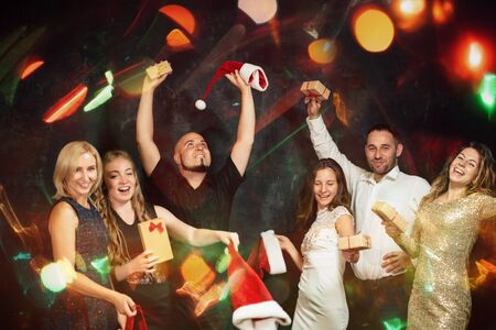 Friends celebrating dancing on Christmas partyの写真素材