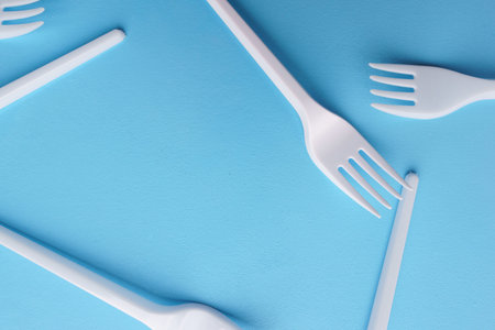 Recycling plastic forks texture on blue
