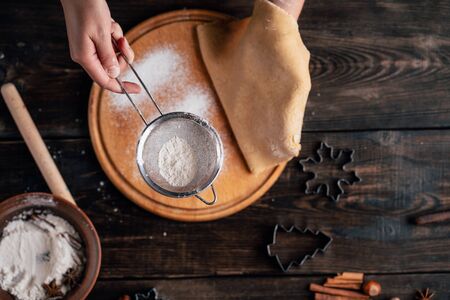 Woman rolling gingerbread dough with rolling pinの写真素材