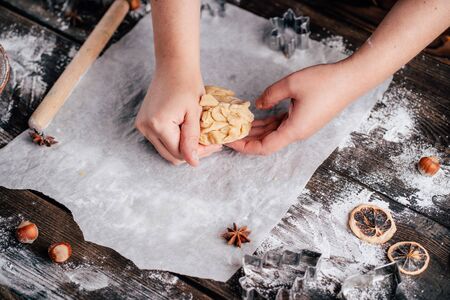 Woman kneading gingerbread dough on pastry boardの写真素材