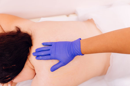 Therapist performing massage on young woman