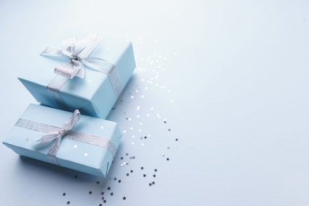 Present with silver ribbon bows on blue background