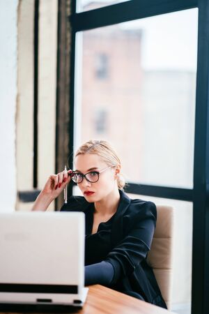 Businesswoman working on laptop at office roomの写真素材