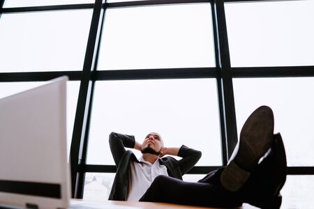 Successful businessman satisfied and relaxedの写真素材