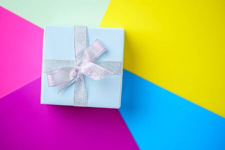 Creative holiday present on multicolored backdropの写真素材