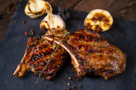 tomahawk rib steak served on slate, grill barbeque
