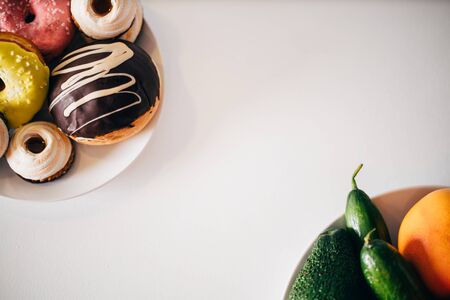 Diet, healthy vs unhealthy food copy space. Vegetables and fruits on table, concept of balanced nutritionの写真素材