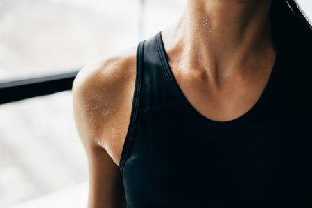 Sweaty muscular body of sporty woman, close up