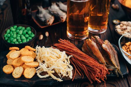 Set of appetizers, salty snacks and light beerの写真素材