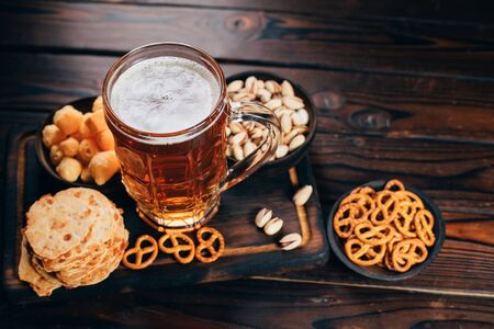 Set of snacks and mug of light beer.の写真素材