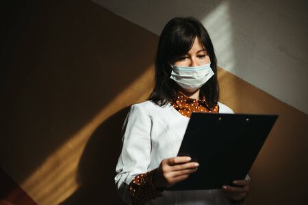 Asian woman in protective medical mask in hospitalの写真素材