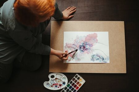 Art therapy, creativity and inspiration. Woman drawing on the floor of design studio.の写真素材