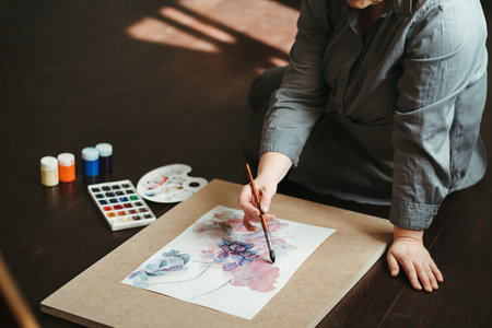 Woman drawing on the floor of design studio.
