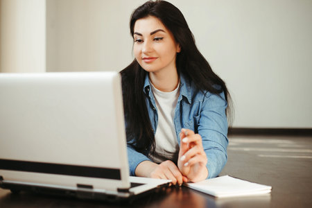 woman looking on laptop screen working from home