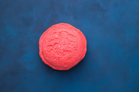 Ice-cream scoop on blue background, copy space