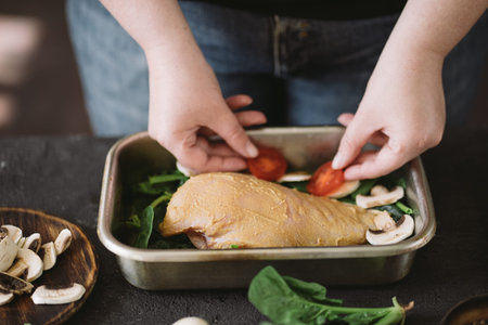 Diet concept, healthy lifestyle, low calorie food. Closeup portrait of woman cooking healthy dinner of chicken meat and vegetablesの写真素材