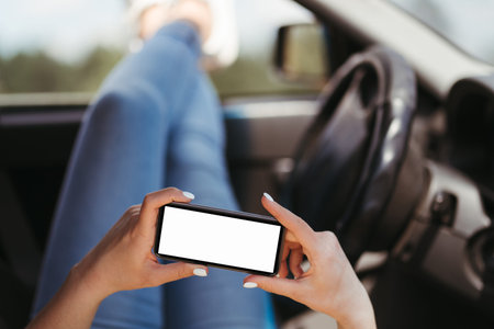 Young woman using mobile app traveling by car