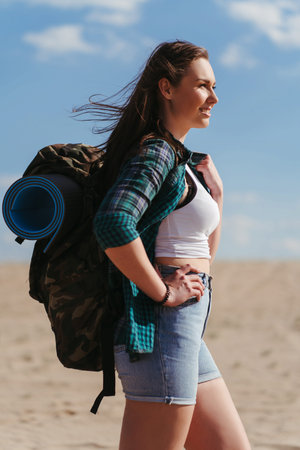 Woman with backpack hiking in desert. Travelingの写真素材