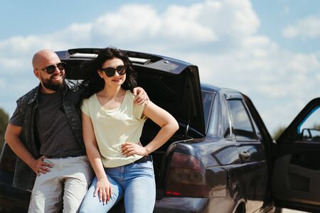 Young joyful couple traveling by carの写真素材