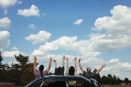 Friends traveling by car enjoy vacation togetherの写真素材