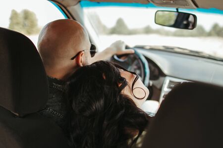 Young joyful couple traveling by carの写真素材