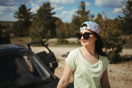 woman traveler sitting on the car hood