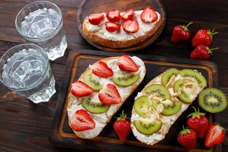 Fruit toasts with kiwi, strawberry and ricottaの写真素材