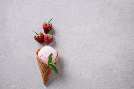 Waffle cone with delicious strawberry ice-cream