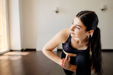 Fit woman doing yoga exercises at her homeの写真素材